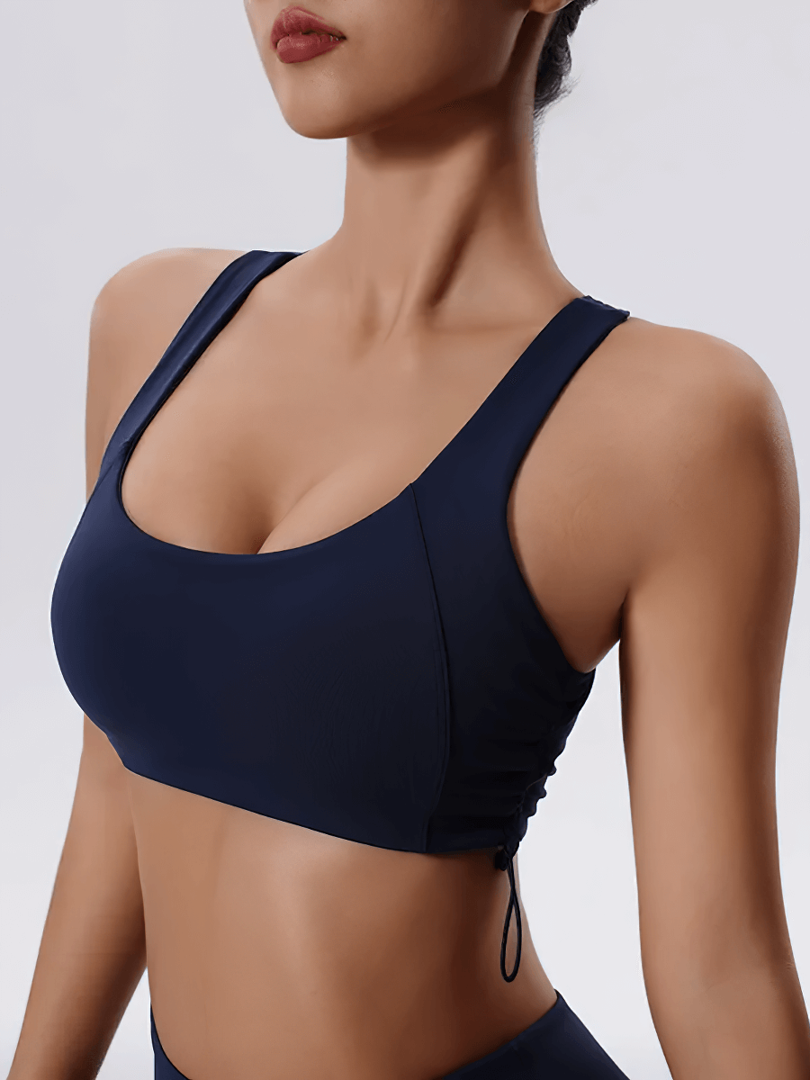 Woman wearing a sexy adjustable sports bra for yoga and fitness with a stylish back design.